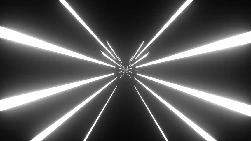 Numerous beams of lights quickly pass by against a black backdrop