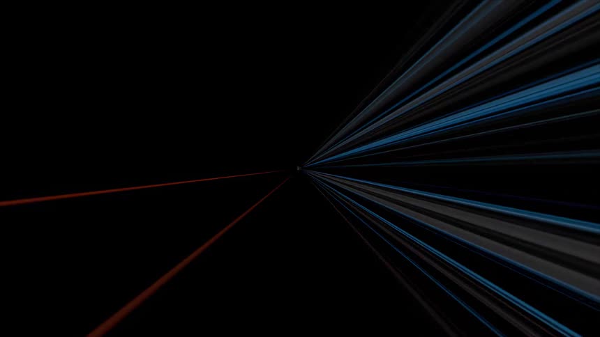 Fast moving streaks of orange and blue light create a sci fi warp speed effect against a black background