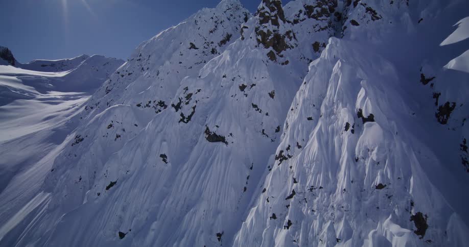 The bright sun glares on the mountains