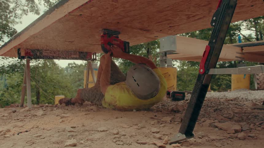 A man cutting wood with a saw