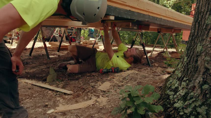 Two construction workers doing some measuring