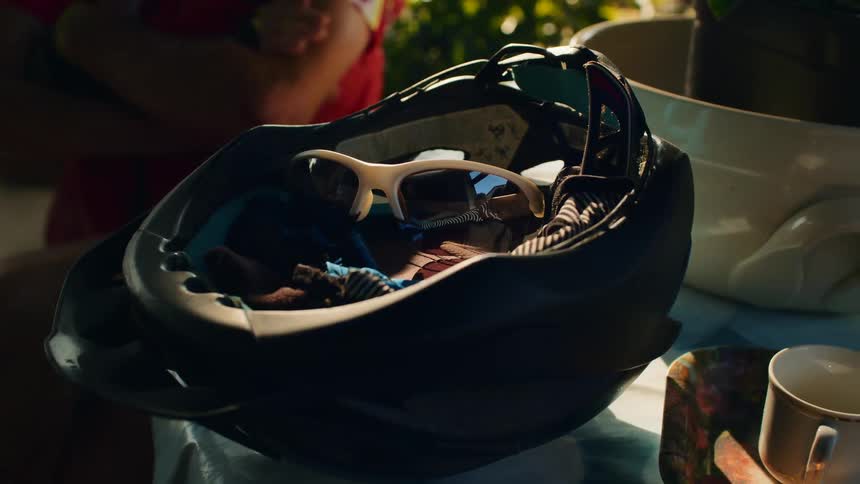 The mans sunglasses are in his cycling helmet