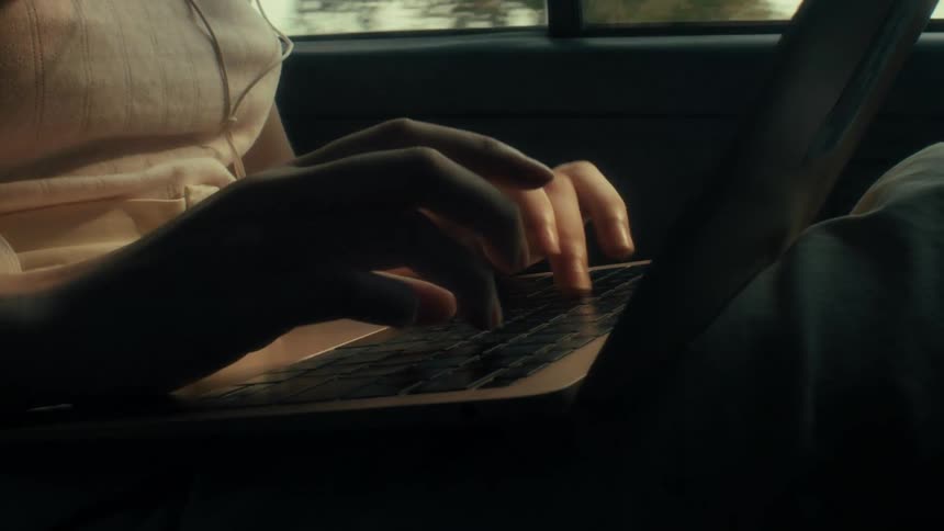 Hands of a person typing on a laptop
