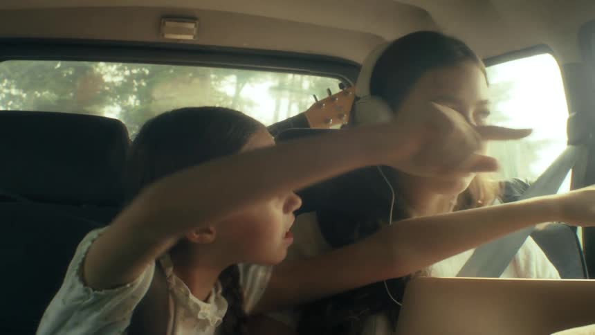Two children playing in a car