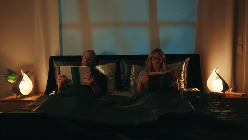 The couple are reading in bed