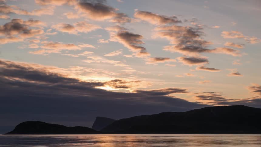The clouds pass over the dawn sky