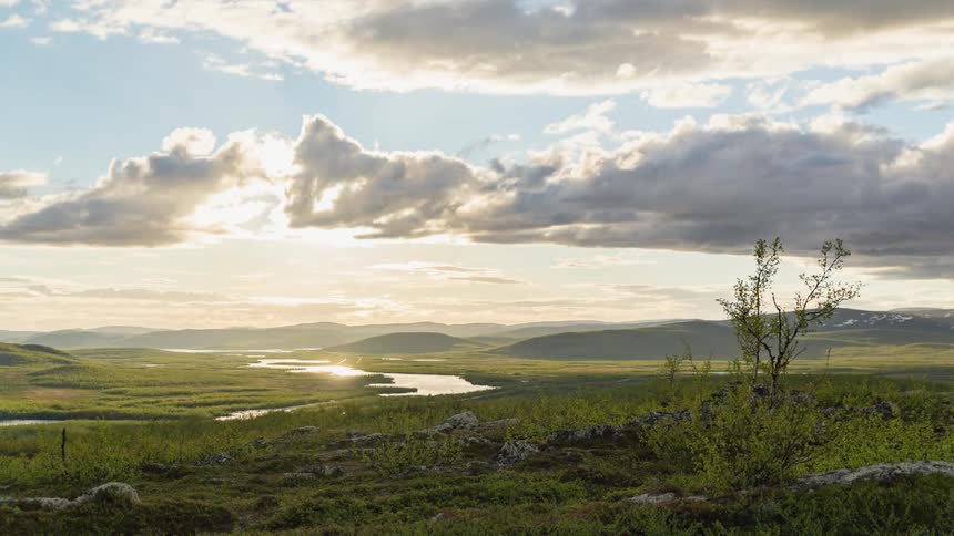 Time lapse of clouds rolling over plains and a river