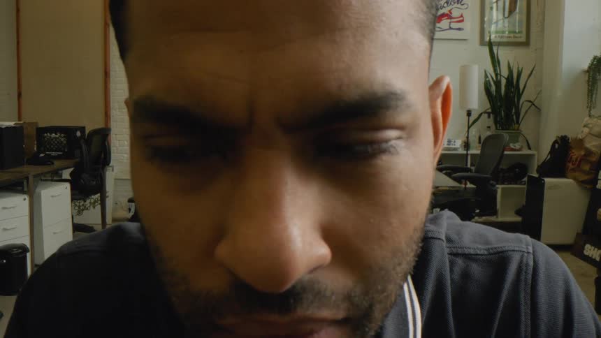 Man sitting in front of a computer in an office scans the computer screen