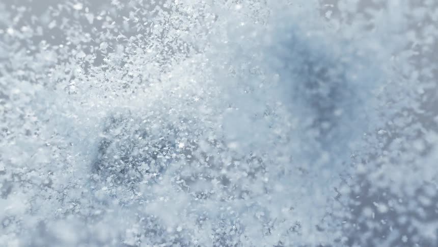 Thousands of tiny shimmering snowflakes swirl and drift in a mesmerizing dance forming elegant cloudlike patterns against a soft gray background
