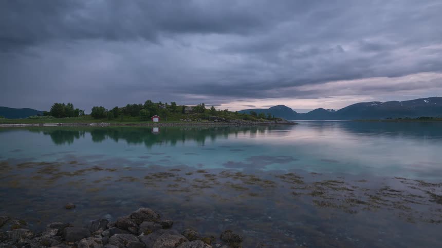 Clouds roll over a clear lake