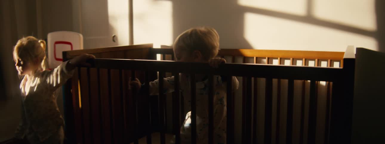 Brother and sister play in the bedroom