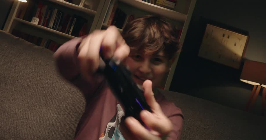The boy is playing video games with a controller