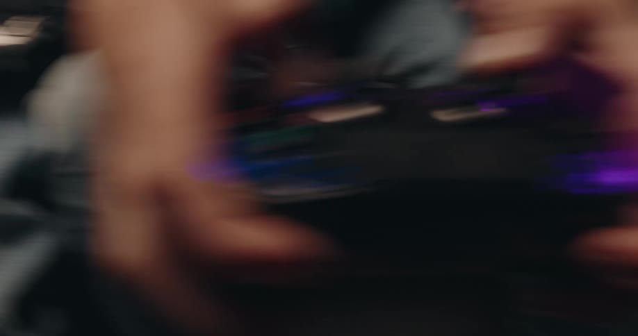 Two kids play video games while sitting on the couch