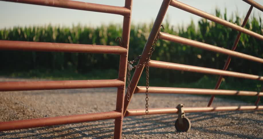 The fence is leaning on the farm