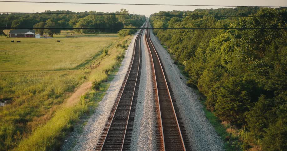 The train tracks run through the rural area