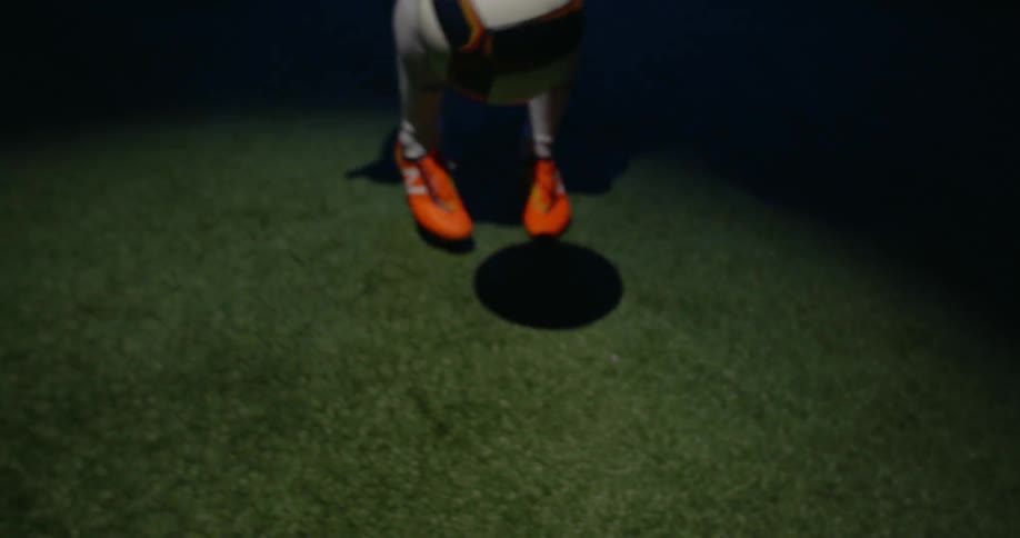 A man is kicking a soccer ball