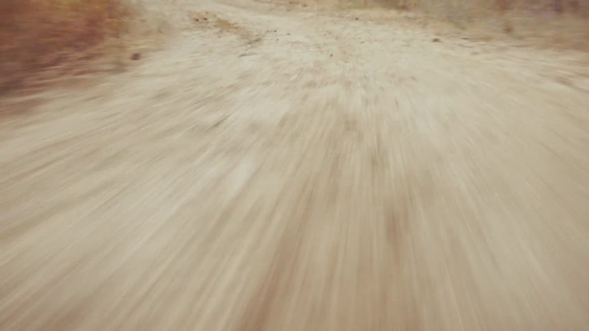 Riding a bike down a dirt path