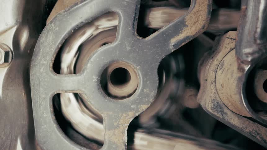 A close up of a gear and chain on a motorcycle