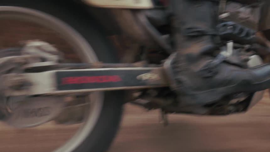 The dirt bike leaves a trail as it races over the dirt