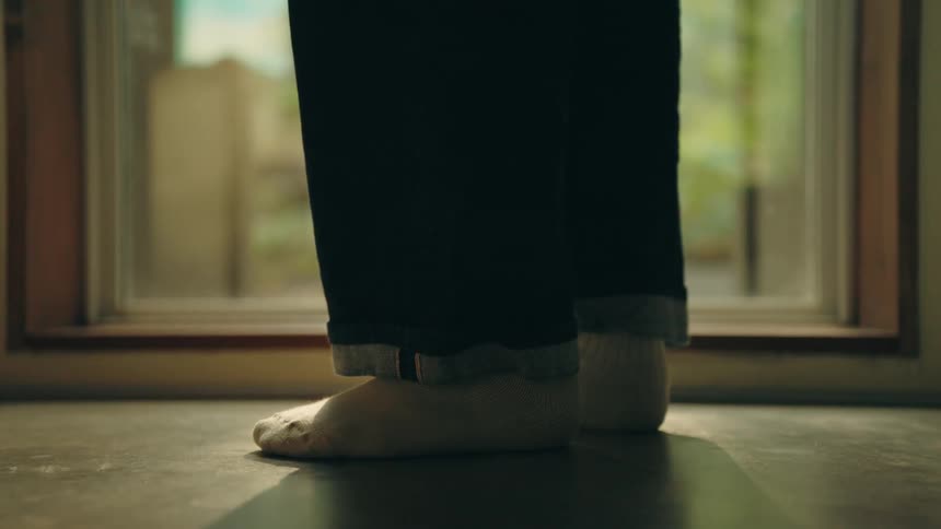 A person walking in front of a window