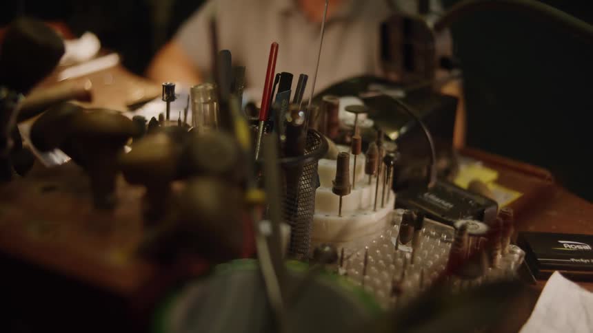 A jeweler working at a desk