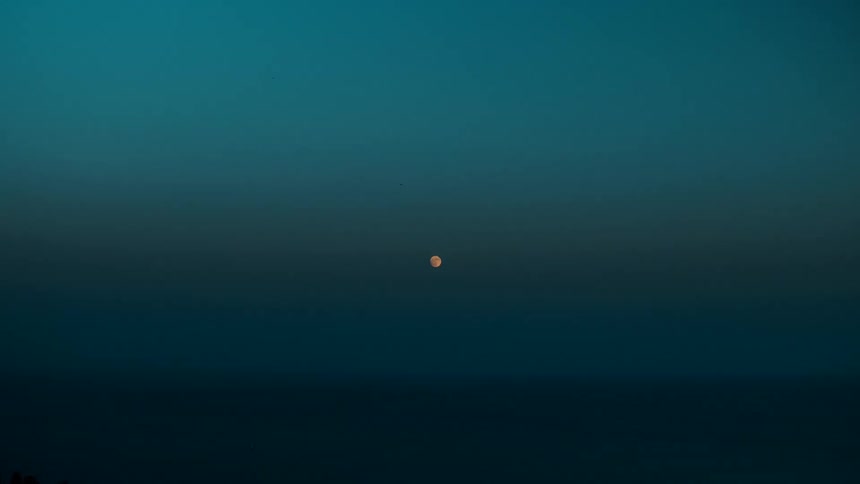 Moon glowing in a deep blue sky