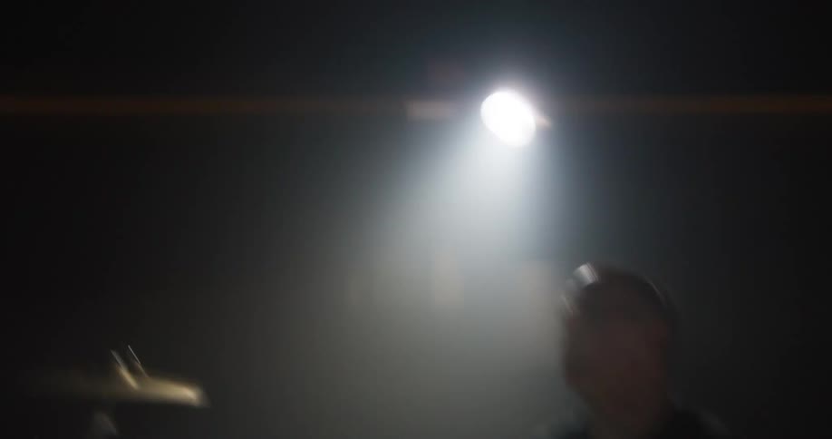 Drummer sweats during a performance on stage