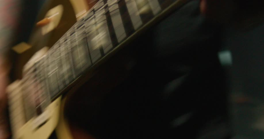 A man is playing an electric guitar