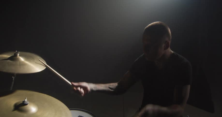 A man playing drums on a stage