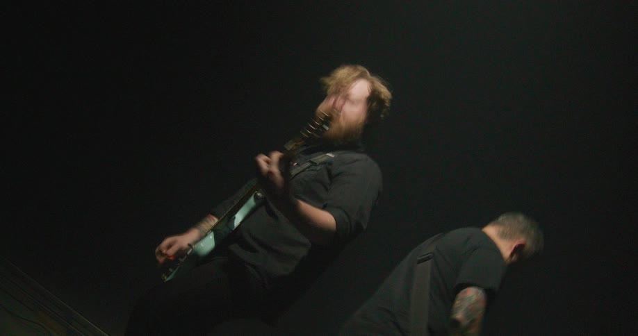 Two men playing guitar and bass