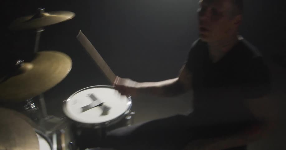 A man playing drums on a stage