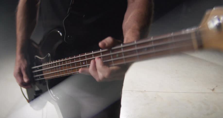 The man strums the guitar