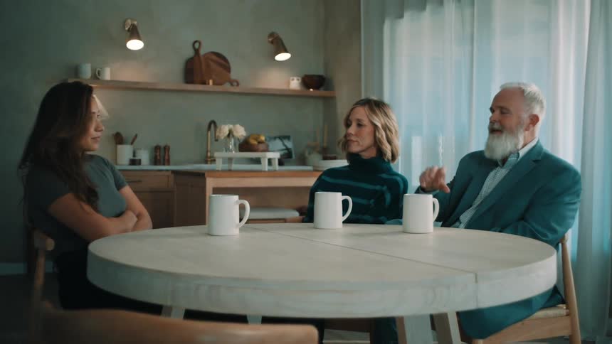 People sitting at a table with coffee having a conversation