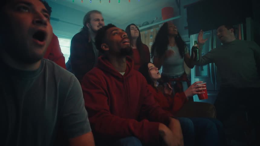 A group of people watching tv in a room