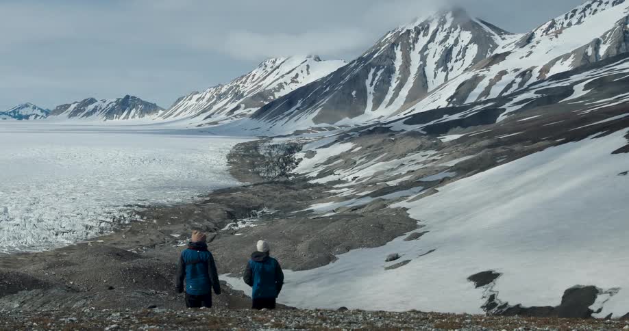 Two people walking out into the arctic