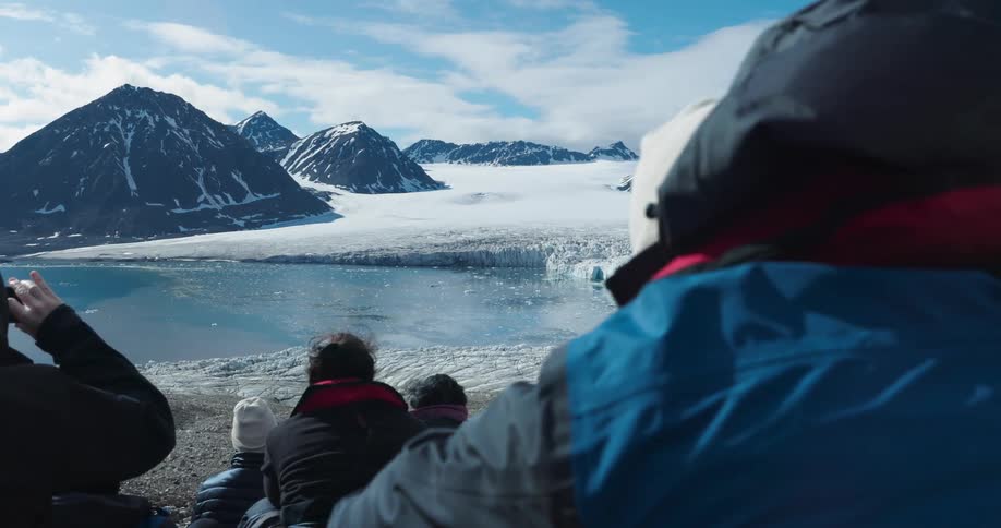 The tourists are seated looking out over the arctic