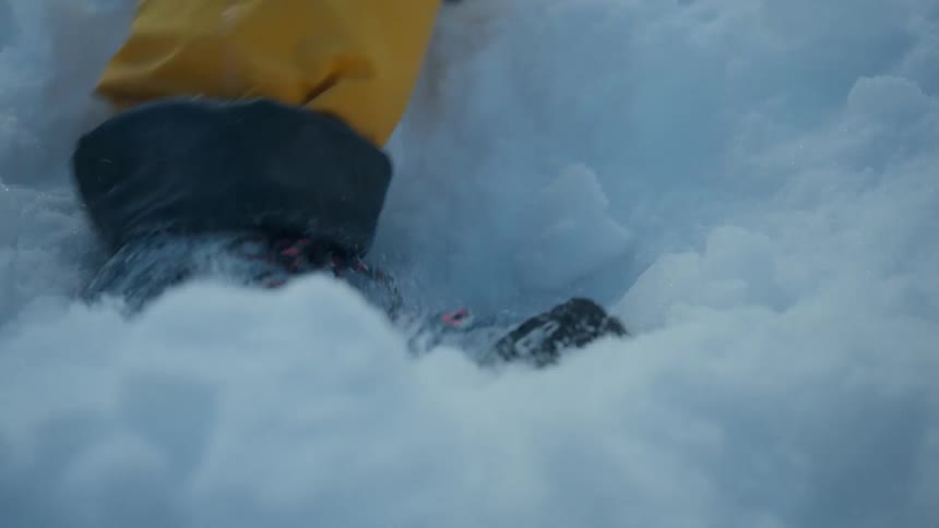 A boot steps into snow
