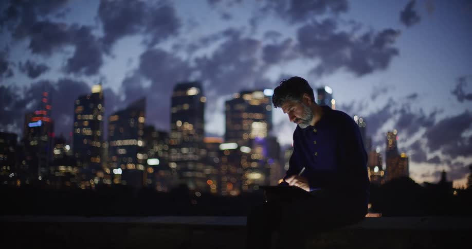 A man looking at a city in the distance