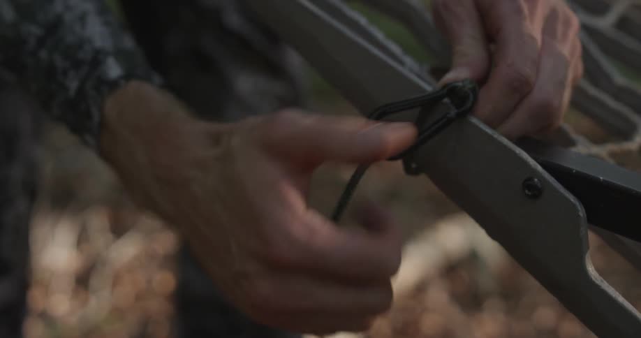 A man attaches a string and clip to a metal object