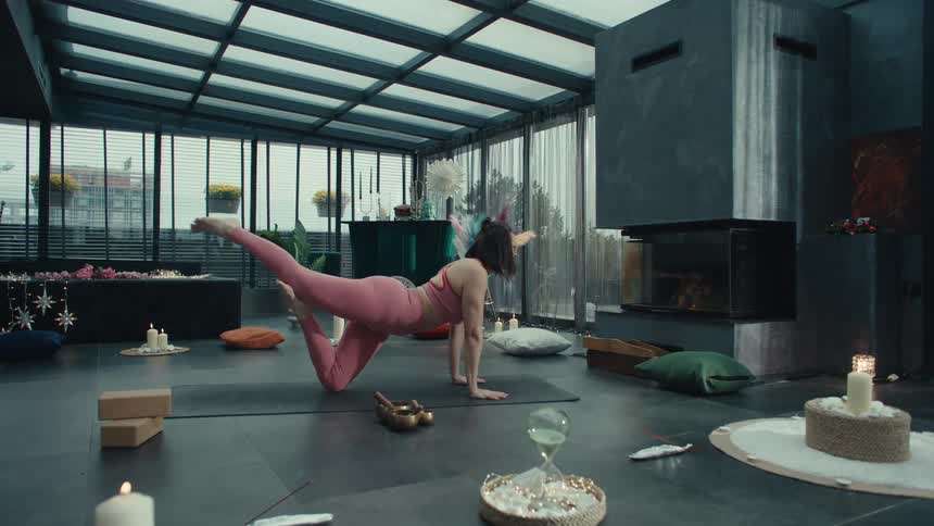 A woman doing yoga in a gym