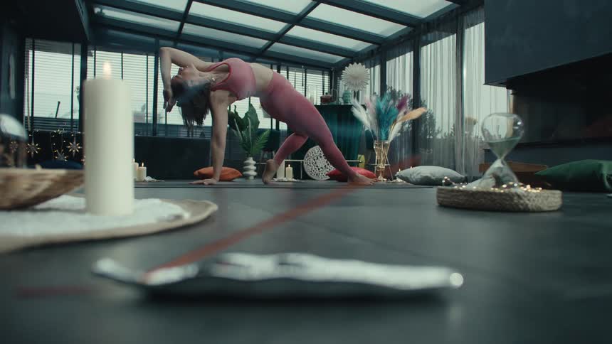 Incense burns as the woman does yoga