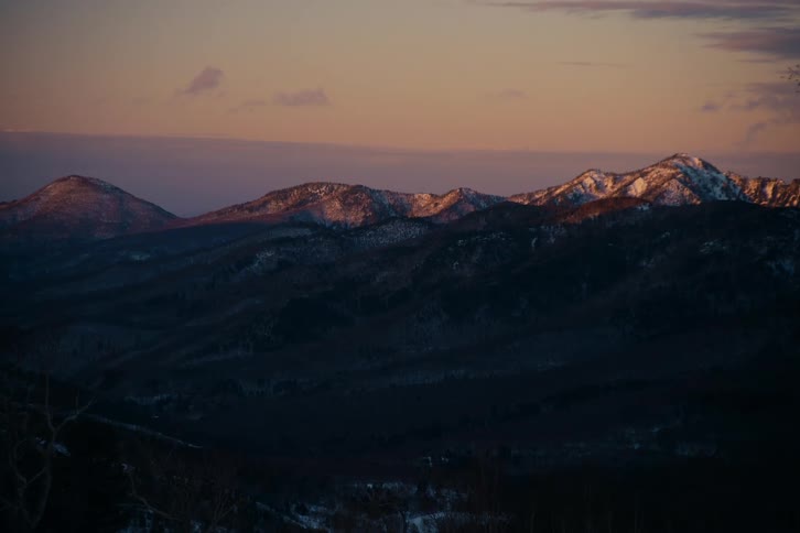 Mountain range with snowdusted peaks under dusk light