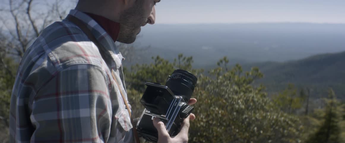 A man adjusts his camera
