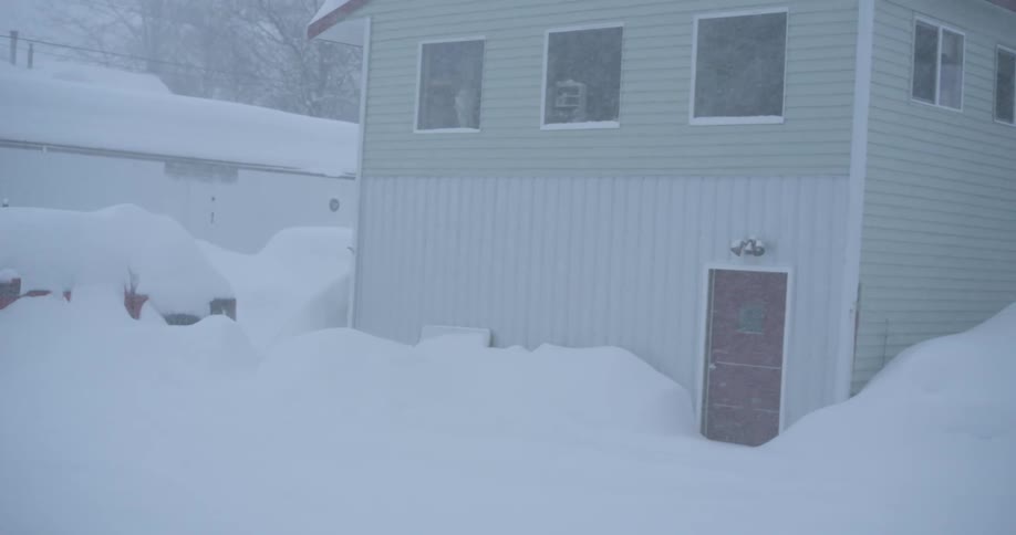 Snow is piling up deep in a residential area