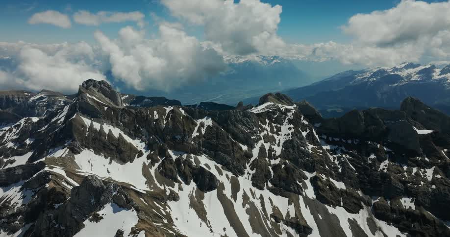 An aerial view of a mountain range covered in snow