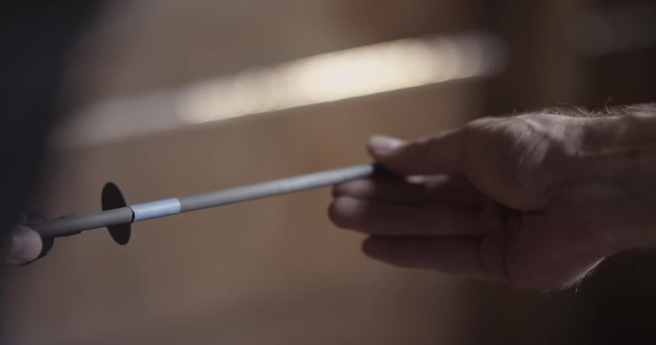 A man saws an arrow until it breaks