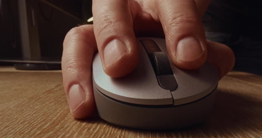 A hand moves a computer mouse