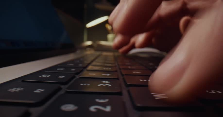 Fingers type on a keyboard