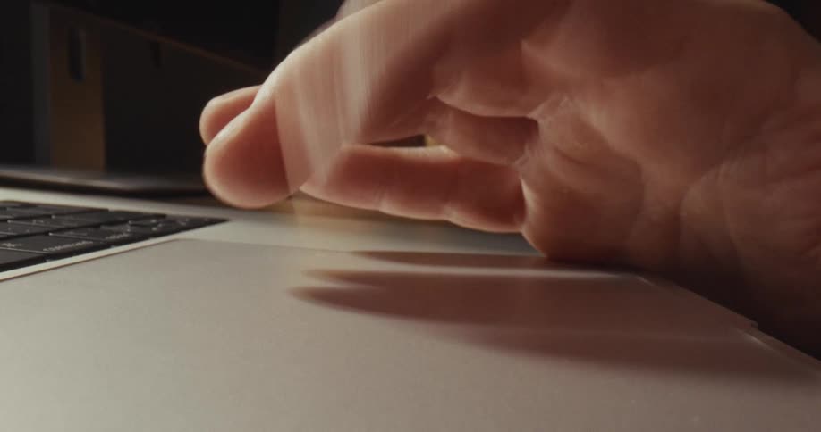 A hand touching a touch pad