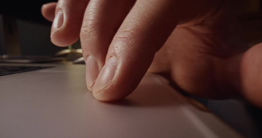 Fingers moving on the touch pad of a laptop computer
